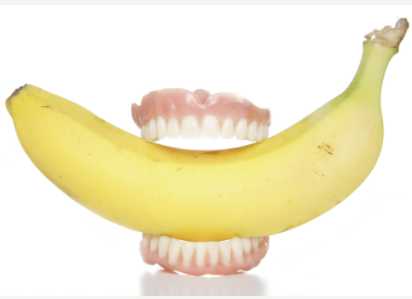 Dentures Biting into a Banana